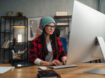 Female video editor works indoors in creative office studio.